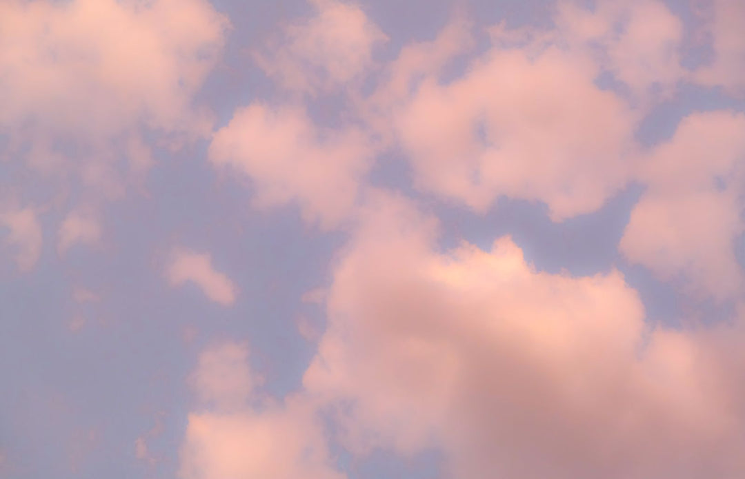 Soft pink clouds in a blue sky